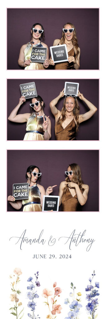 Two women posing with signs
