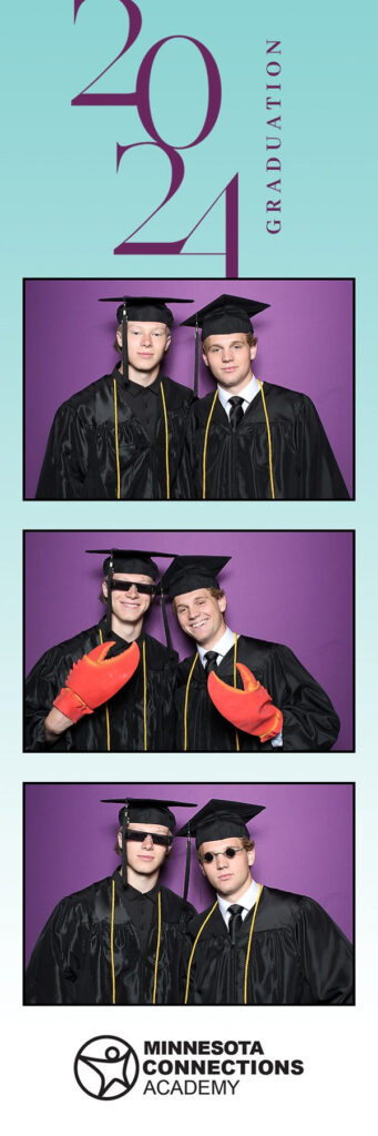 Two man in graduation gowns and caps