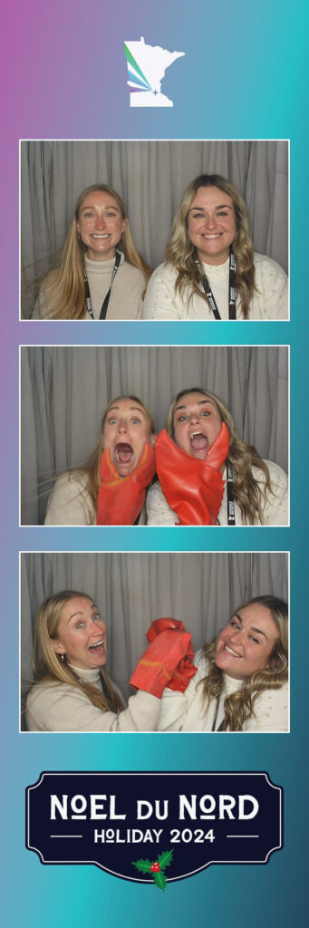 Two women posing in a photo booth